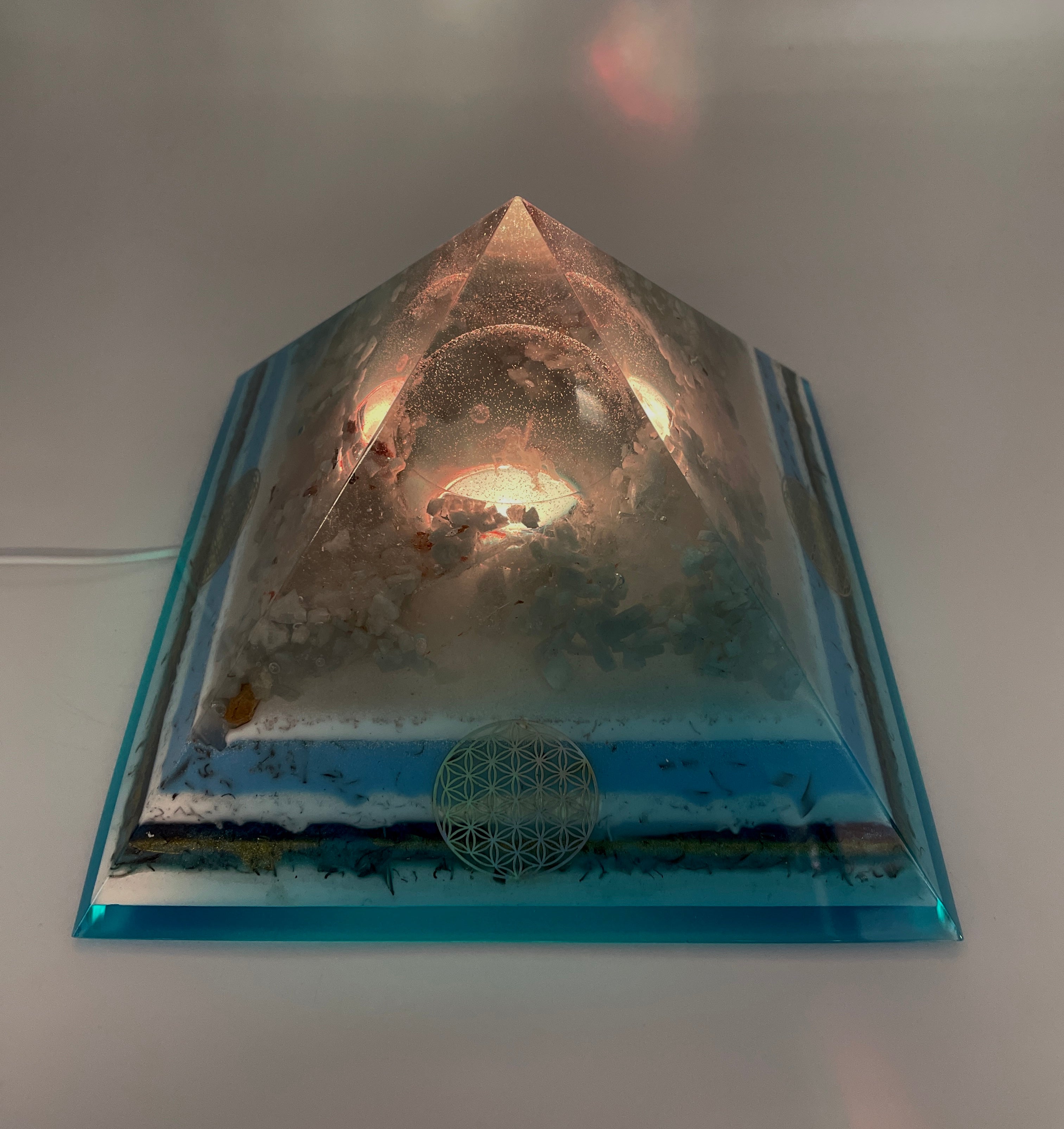Orgonpyramide mit Blaucalcit und beleuchtetem Pegasus in Glaskugel